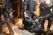 Un policía, cargado por sus compañeros tras ser herido en los enfrentamientos con los manifestantes en Via Laietana, este viernes.-MANU MITRU