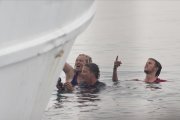 Activistas en el agua intentan impedir la marcha de un ferri que traslada a refugiados de vuelta a Turquía en el puerto de Mitilene (Grecia), en Lesbos.-AP / PETROS GIANNAKOURIS