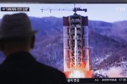 Un hombre observa imágenes televisivas de archivo del lanzamiento de un misil norcoreano, este jueves, en Seúl.-AFP / AHN YOUNG-JOON