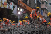 Trabajadores de emergencias indios en las tareas de rescate tras el derrumbamiento de un puente en Calcuta, India.-DIBYANGSHU SARKAR