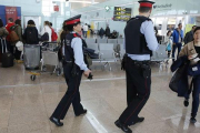 Dos 'mossos' participan en el servicio de vigilancia reforzada del aeropuerto de El Prat.-JOAN PUIG