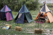Los participantes de las actividades en la ribera del Arlanzón, ayer, protegidos de la lluvia en las tiendas.-SANTI OTERO