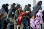 Refugiados se cubren con mantas tras cruzar la frontera entre Hungria y Austria en Nickelsdorf,  Austria, en septiembre del 2015.-EFE / ROLAND SCHLAGER