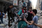 Un hombre saca el cadáver de un niño de una casa alcanzada por un bombardeo en Alepo.-AMEER ALHALBI / AFP