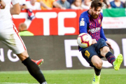 Messi dispara a la portería del Sevilla.-RAÚL CARO (EFE)