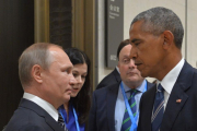 Putin y Obama se miran antes de su encuentro en el G20.-ALEXEI DRUZHININ / AFP