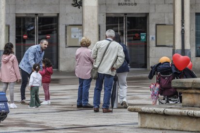 Una pareja de jubilados y una mujer de mediana edad frente al Ayuntamiento de Burgos.