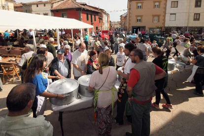 Un grupo de comensales espera a que las ollas se abran para recibir su correspondiente ración.-G.G.