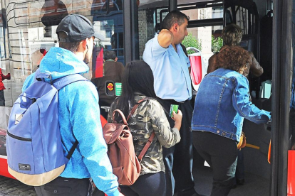 Dos jóvenes acceden al autobús municipal en una parada del centro.-ISRAEL L. MURILLO