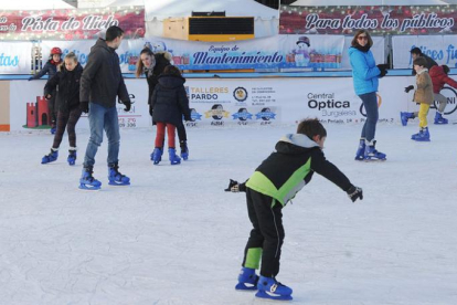Varias personas disfrutan de la pista de hielo en su último día de apertura.-ISRAEL L. MURILLO