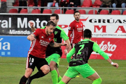 Borja Sánchez se va de dos rivales durante un partido de la pasada temporada con la camiseta del Mirandés.-ALFONSO G. MARDONES