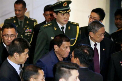 Duterte (con camisa azul), en Pekín.-REUTERS / JASON LEE