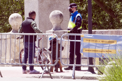 Un agente de la Policía Local conversa con un ciudadano en el puente de San Pablo. ISRAEL L. MURILLO