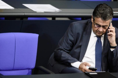 El ministro de Exteriores aleman,  Sigmar Gabriel,  atiende el telefono durante una sesion del Bundestag  en Berlin.-/ EFE / CLEMENS BILAN