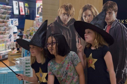 Fans de Harry Potter, la noche del sábado al domingo en Singapur, celebrando el lanzamiento mundial del nuevo libro de la saga del niño mago.-AFP / ROSLAN RAHMAN