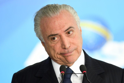 Las autoridades investigan si un decreto sancionado por Temer en 2017 y que alteró la ley de puertos benefició a algunas empresas del sector.-AFP