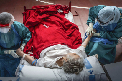 Dos sanitarias atienden a una paciente en el hospital de campaña de Aranda de Duero. PACO SANTAMARÍA