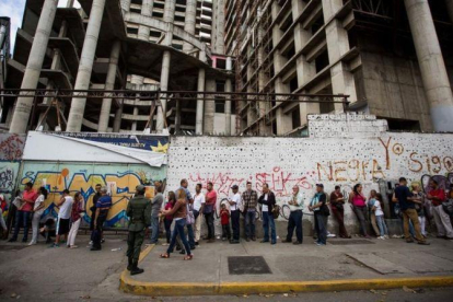 Un grupo de personas aguardan para realizar transacciones bancarias, en Caracas, el 13 de diciembre.-EFE / MIGUEL GUTIERREZ