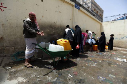 Yemenís llenan de agua potable botellas de plástico en una fuente de Saná.-Foto:   EFE / YAHYA ARHAB