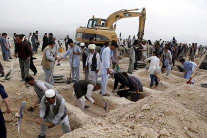 Decenas de personas han acudido a un cementerio de Kabul a cavar tumbas para las víctimas del atentado.-JAWAD JALALI / EFE