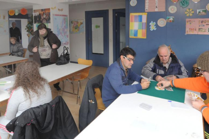 Varios usuarios de Prosame juegan a las cartas y dibujan ayer en las instalaciones de la asociación.-ISRAEL L. MURILLO