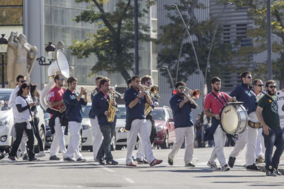 Miembros de la charangaextraperlo cruzan la calle camino del centro histórico.-SANTI OTERO
