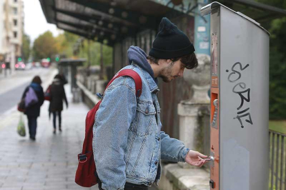 Un joven recarga su tarjeta en una máquina de la ciudad.-RAÚL G. OCHOA