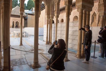 Unos turistas fotografían el Patio de los Leones de la Alhambra de Granada.-EFE/Archivo