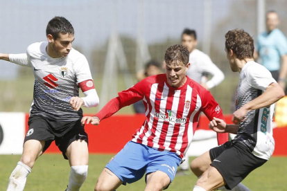 Sergio Esteban y Beobide presionan a un futbolista del Sporting B.-ARNALDO GARCÍA