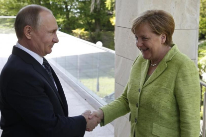 Putin da la bienvenida a Merkel a su llegada a Sochi.-YURI KOCHELKOV