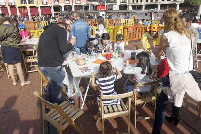 Varios niños y sus padres participan en los talleres organizados en una de las ediciones de la celebración. SANTI OTERO