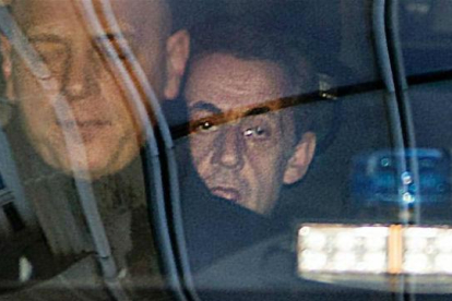 Sarkozy (detrás), a su llegada al tribunal de París para declarar por el 'caso Bygmalion'.-AFP / THOMAS SAMSON