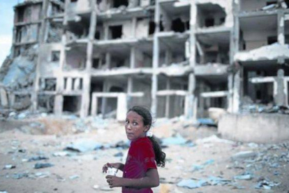 Una niña palestina junto un bloque de casas destruido en el norte de la franja de Gaza.-Foto: REUTERS / SUHAIB SALEM