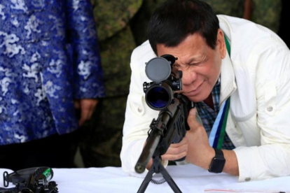 Duterte comprueba la mirilla de un rifle, hace unos días.-REUTERS / ROMEO RANOCO