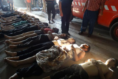 Una fila de cuerpos de supuestas víctimas del ataque con armas químicas.-AP