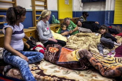 Una familia en el gimnasio de una de las escuelas ocupadas en Lyon.-Foto: AFP / JEFF PACHOUD