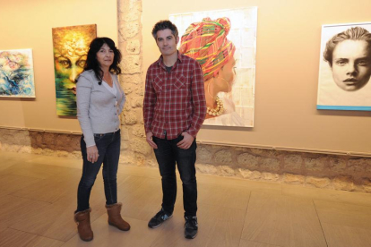 Isis de Lázaro y Juan Martín Oña, delante de dos de sus respectivas pinturas expuestas en el Arco de Santa María.-Israel L. Murillo