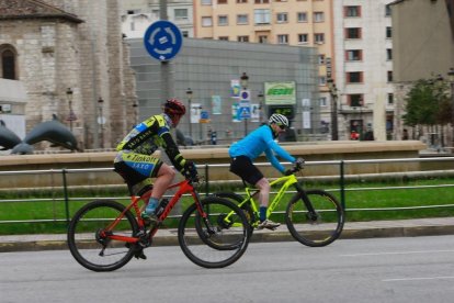 Dos ciclistas por la fuente de los Delfines esta mañana. / RAÚL G. OCHOA