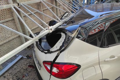 Vehículo afectado por la caída del andamio.