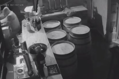 Fotograma de la grabación que muestra al ladrón tratando de arrancar el cajón de la recaudación de un bar.