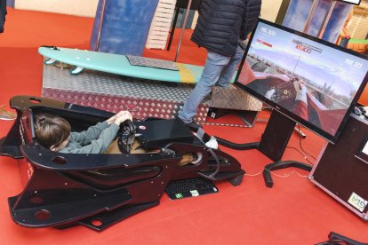 Un niño metido en el cockpit de un simulador racing.