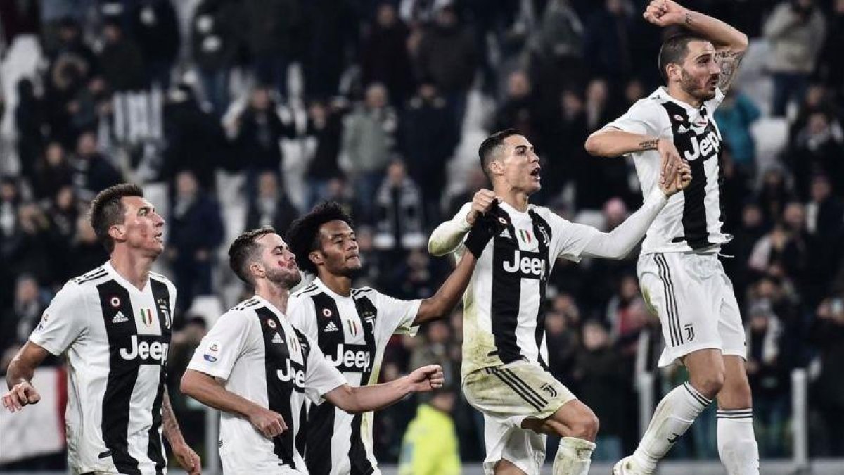 Los jugadores de la Juventus, con Cristiano en el centro, celebran la nueva victoria.-EL PERIÓDICO