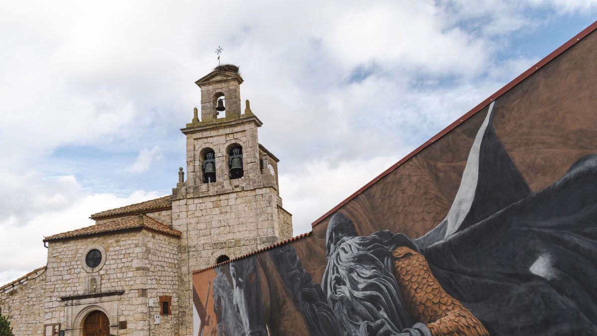 Imagen de un mural sobre el Cid Campeador con la iglesia de la Natividad de Nuestra Señora al fondo.