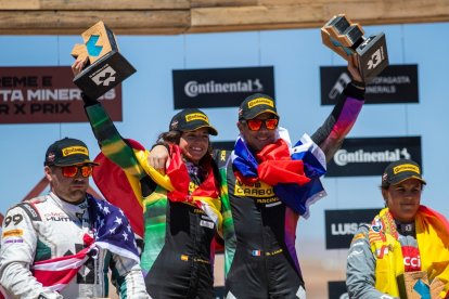 La piloto burgalesa junto a Loeb, pertrechados con las banderas nacionales, celebran el título. ECB