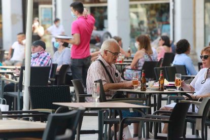 Varias personas disfrutan del buen tiempo en una terraza de la capital burgalesa. ECB