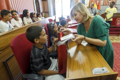 Sonia Rodríguez, concejala de asuntos sociales del Ayuntamiento de Burgos, entrega un regalo a un pequeño refugiado recién llegado de África. SANTI OTERO