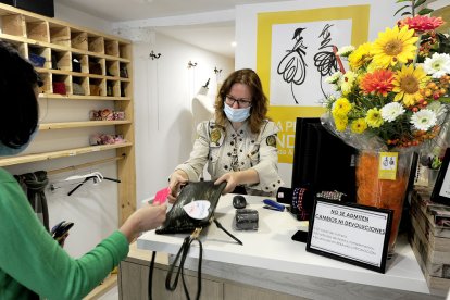 Una mujer utiliza los bonos al consumo en un establecimiento de la capital. ISRAEL L. MURILLO