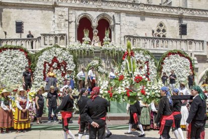 Miembros de la comitiva portan flores para honrar a la virgen.-SANTI OTERO