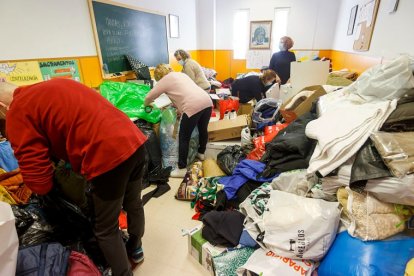 Un grupo de voluntarios organiza el material en la parroquia de Nuestra Señora del Rosario, en Fuentecillas que se vió desbordada por tanta solidaridad. SANTI OTERO