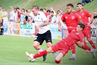 Borja Sánchez trata de zafarse del marcaje de un defensor del CD Numancia en el choque de ayer disputado en la Ciudad Deportiva Francisco Rubio de Soria-Burgos CF